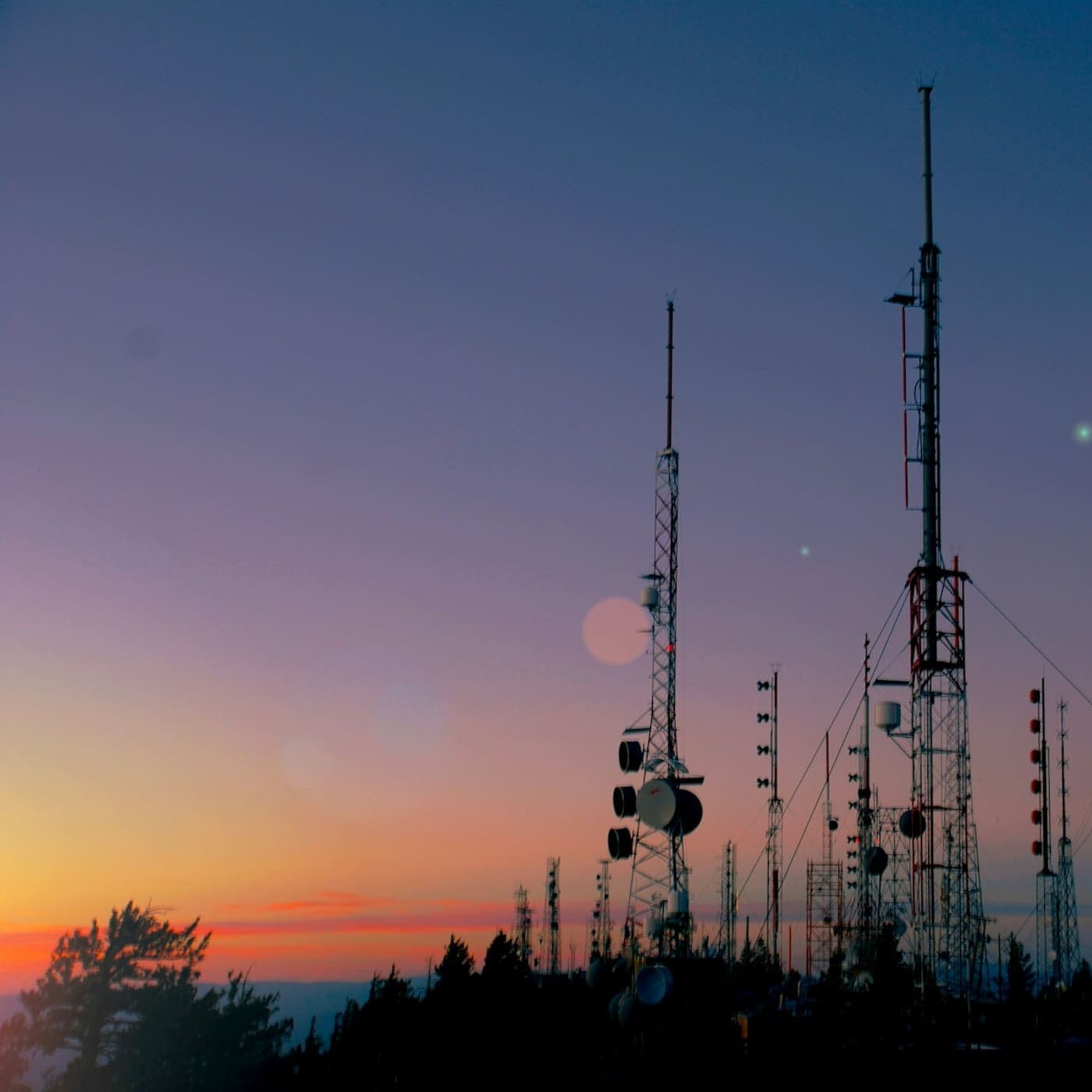 Radio towers on a ridge at sunset